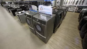 The Kenmore Elite Smart Electric Dryer and Front Load Washer, center, appears on display at a Sears store on Thursday, July 20, 2017. Smart appliances such as this connect with each other and with mobile platforms to increase efficiency. (AP Photo/Rick Bowmer)