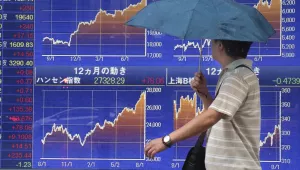 A man views the electronic stock indicator of a securities firm in Tokyo, Tuesday, Aug. 15, 2017. Asian shares rose Tuesday as both Koreas and the U.S. appeared to indicate a willingness to defuse the crisis over North Korea's nuclear program. A rally on Wall Street, on the back of strong technology shares, also helped. (AP Photo/Shizuo Kambayashi)