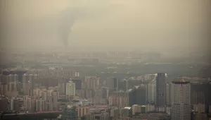 Smoke rises above the skyline of Beijing on a moderately polluted day, Saturday, Aug. 26, 2017. (AP Photo/Mark Schiefelbein)