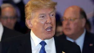 U.S. President Donald Trump speaks as he walks during the annual meeting of the World Economic Forum in Davos, Switzerland, January 25, 2018. (AP Photo/Markus Schreiber)