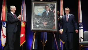 Defense Secretary James Mattis, left, applauds former Defense Secretary Ash Carter, right, during the portrait unveiling ceremony for the former secretary at the Pentagon on Friday, Feb. 2, 2018. (AP Photo/Jacquelyn Martin)