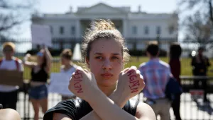 Gwendolyn Frantz, 17, of Kensington, Md., stands in front of the White House during a student protest for gun control on Wednesday, Feb. 21, 2018, in Washington. (AP Photo/Evan Vucci)