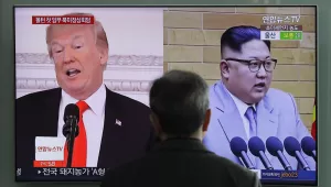 A man watches a TV screen showing file images of U.S. President Donald Trump, left, and North Korean leader Kim Jong Un, right, during a news program at the Seoul Railway Station in Seoul, South Korea. March 27, 2018 (Lee Jin-man/Associated Press). Keywords: Donald Trump, Kim Jong-Un, nuclear