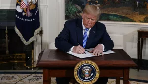 President Donald Trump signs a Presidential Memorandum on the Iran nuclear deal from the Diplomatic Reception Room of the White House, Tuesday, May 8, 2018, in Washington. Trump announced the U.S. will pull out of the landmark nuclear accord with Iran, dealing a profound blow to U.S. allies and potentially deepening the president's isolation on the world stage. 