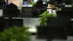 A Watrix employee works at his desk in their company’s offices in Beijing, October 31, 2018. Watrix, a Chinese technology startup hopes to begin selling software that recognizes people by their body shape and how they walk, enabling identification when faces are hidden from cameras.