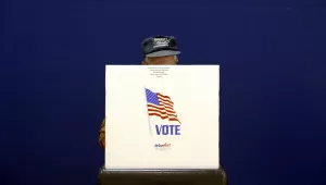 A voter fills out a ballot at a polling place.