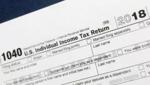 This July 24, 2018, file photo shows a portion of the 1040 U.S. Individual Income Tax Return form for 2018 in New York. If you’ve lost or never received your W-2, old tax returns, 1099s or 1098s to complete your tax return, there are a few things you can do to get back on track and give yourself more time. 