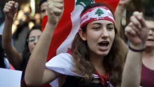 Protester chant slogans during ongoing protests against the Lebanese government, in front of the central bank, in Beirut, Lebanon, Monday, Oct. 28, 2019. The protests have paralyzed the country but have been largely peaceful.