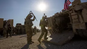 Crewmen enter Bradley fighting vehicles at a US military base at an undisclosed location in Northeastern Syria.