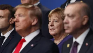 From left, French President Emmanuel Macron, U.S. President Donald Trump, German Chancellor Angela Merkel and Turkish President Recep Tayyip Erdogan pose during a group photo for a NATO leaders meeting at The Grove hotel and resort in Watford, Hertfordshire, England, Wednesday, Dec. 4, 2019.