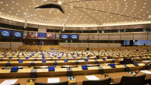 A MEP walks in the mostly-vacant Plenary chamber of the European Parliament in Brussels, Tuesday, March 10, 2020.