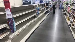 A shopper looks at items near empty shelves at a grocery store in Warrington, Pa., Tuesday, March 17, 2020. Coronavirus concerns have led to consumer panic buying of grocery staples. (AP Photo/Matt Rourke)