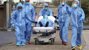 A person is taken on a stretcher into the United Memorial Medical Center after going through testing for COVID-19 Thursday, March 19, 2020, in Houston. 