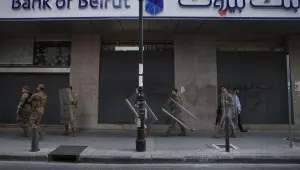Lebanese soldiers secure a bank, after the anti-government protesters try to destroy banks windows during a protest against the Lebanese central bank's governor Riad Salameh and against the deepening financial crisis, at Hamra trade street, in Beirut, Lebanon.