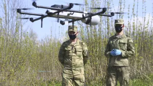 Russian National Guard soldiers operate a surveillance drone in Losiny Ostrov national park in northeastern Moscow, Sunday, May 3, 2020.