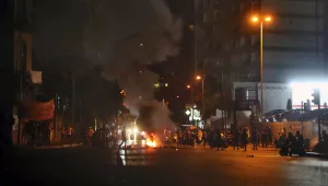 Anti-government demonstrators burn tires to block a road in Beirut on Tuesday. 