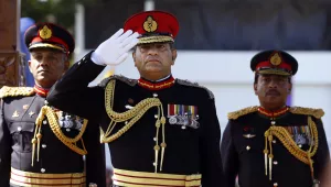 Sri Lankan army commander Lt. Gen. Jagath Jayasuriya, center, salutes as the next Army Commander Major Gen. Daya Ratnayake, left, and Major Gen. Jagath Dias watch a military parade in Colombo, Sri Lanka, Tuesday, July 30, 2013. Ratnayake is the Sri Lankan army's 20th commander designate and will resume duties from August 1, 2013. (AP Photo/Eranga Jayawardena)