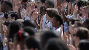 Photo of AmeriCorps volunteers taking a pledge as President Barack Obama and former President Bill Clinton mark the 20th anniversary of AmeriCorps, which promotes volunteerism and community service, on the South Lawn at the White House in Washington, Friday, Sept. 12, 2014. 