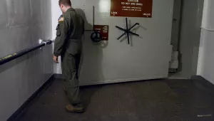 A lieutenant opens a blast door at a U.S. ICBM launch control facility.