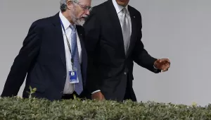 John P. Holdren walking with President Barak Obama on Friday, March 7, 2014. At the time, Holdren was serving as Assistant to the President for Science and Technology and Director of the White House Office of Science and Technology Policy. (AP Photo/Charles Dharapak)