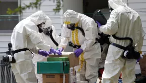 On April 19, 2013, federal agents wearing hazardous material suits and breathing apparatus inspect the home and possessions of a Mississippi man who was later convicted for mailing ricin to President Obama (AP Photo/Rogelio V. Solis)