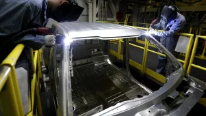 In this March 13, 2015 photo, workers weld body panels on the new aluminum-alloy body Ford F-150 truck at the company's Kansas City Assembly Plant in Claycomo, Mo (AP Photo/Charlie Riedel).