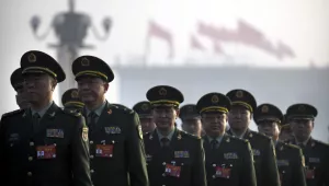 Military delegates arrive at the Great Hall of the People before the opening session of China's National People's Congress