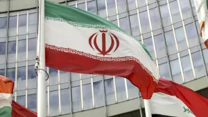 The Iranian flag waves outside of the UN building that hosts the International Atomic Energy Agency