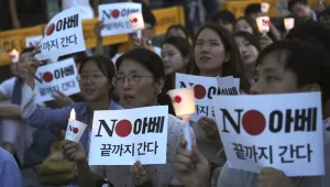 South Korean protesters holding signs