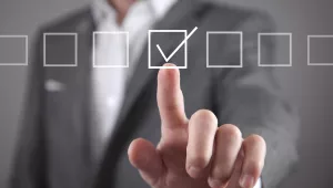 A picture of a man marking off checkboxes 