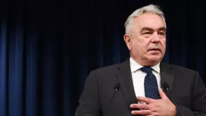 Kurt Campbell against a dark blue curtain backdrop.