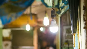 Energy efficient LED light bulbs hang in an Indian home