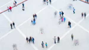 Blurred photo of people in a square from above.