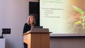 Ashlie Burkart presents at podium