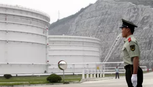 Security guards watch near oil tanks at Zhoushan Oil Reserve in Zhoushan in Zhejiang Province, China, June 3, 2009.