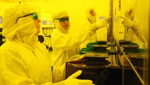 Technicians in clean room learn to make semiconductors
