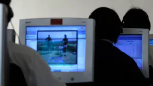 Rows of people using computers in North Korea.