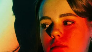 Image of a person's face with rainbow light covering their face