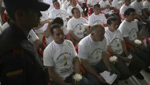 In this March 11, 2009 file photo, a group of rebels of the Revolutionary Armed Forces of Colombia attend a ceremony where they graduated as "peacemakers" after they renounced the rebel group and the armed struggle, at La Picota prison in southern Bogota, Colombia. 