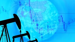 silhouetted oil rigs against blue background