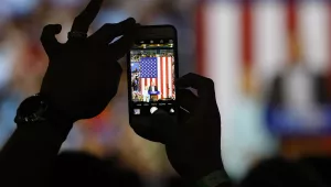 An attendee shoots a photo on a cell phone of Democratic U.S vice presidential candidate Senator Tim Kaine speaking as he appears with Democratic U.S. presidential candidate Hillary Clinton during a campaign rally in Miami, Florida, U.S. July 23, 2016.