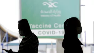 People walk outside a coronavirus vaccine center at the old Jiddah airport, Saudi Arabia, Tuesday, May 18, 2021