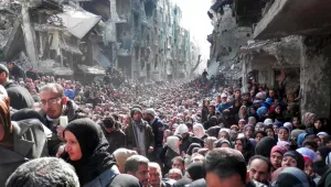 Residents of the Palestinian refugee camp of Yarmouk, lined up to receive food supplies, in Damascus, Syria, in 2014.