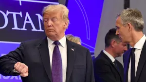 U.S. President Donald Trump Checks the Time as NATO Secretary General Jens Stoltenberg Stands Beside Him