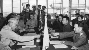 In this July 27, 1953, file photo, US Maj. Gen. Blackshear M. Bryan, left, exchanges credentials with North Korean Lt. Gen. Lee Sang Cho at the opening session of the Military Armistice Commission at the Panmunjom Conference House.