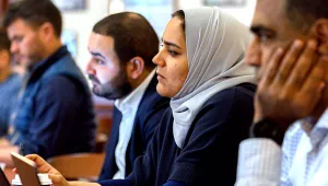 Students in a row listening to a speaker at a study group session.