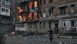 A local resident leaves his home after Russian shelling destroyed an apartment house in Bakhmut, Donetsk region, Ukraine, Wednesday, Dec. 7, 2022.