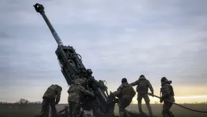 Ukrainian soldiers prepare a U.S.-supplied M777 howitzer to fire at Russian positions in Kherson region, Ukraine, Jan. 9, 2023.