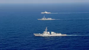The Arleigh Burke-class guided-missile destroyer USS Dewey (DDG 105), front, and the Independence-variant littoral combat ship USS Gabrielle Giffords (LCS 10), rear, conduct joint operations with the Japan Maritime Self-Defense Force destroyer JS Akebono (DD-108) in the South China Sea