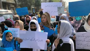 Afghan women chant and hold signs of protest